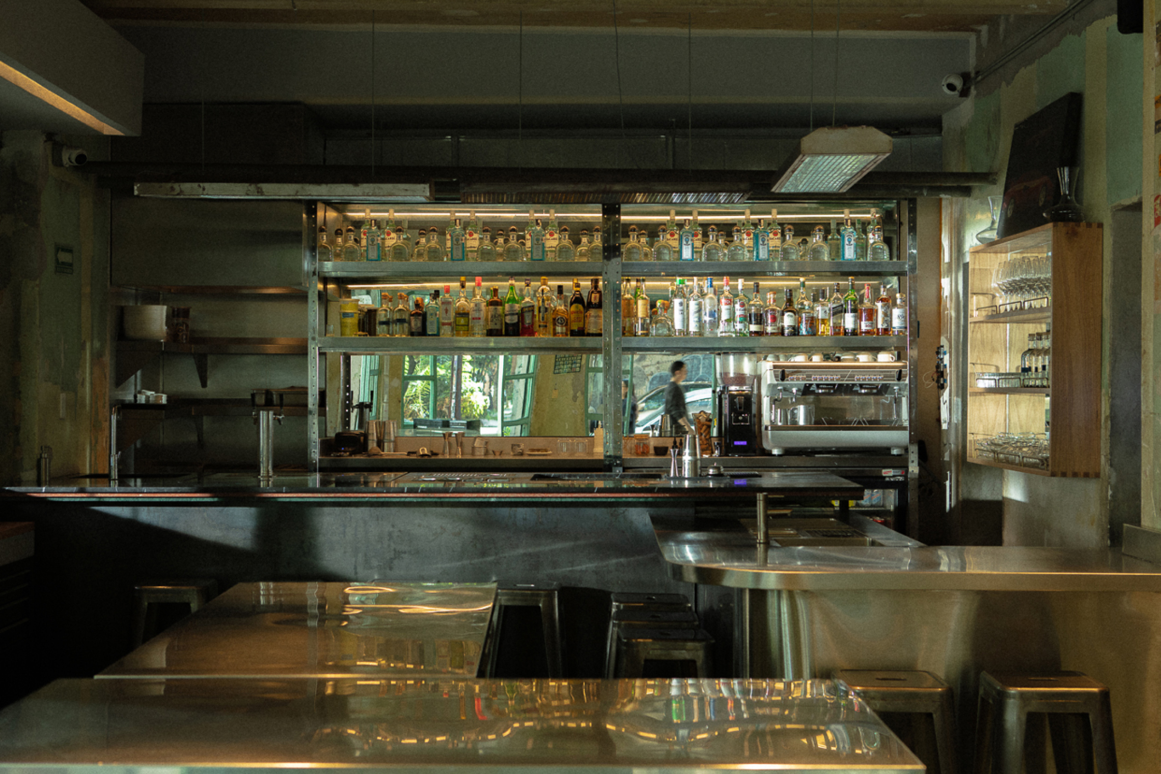 Industrial interior design of Voraz restaurant with steel bar and warm lighting.