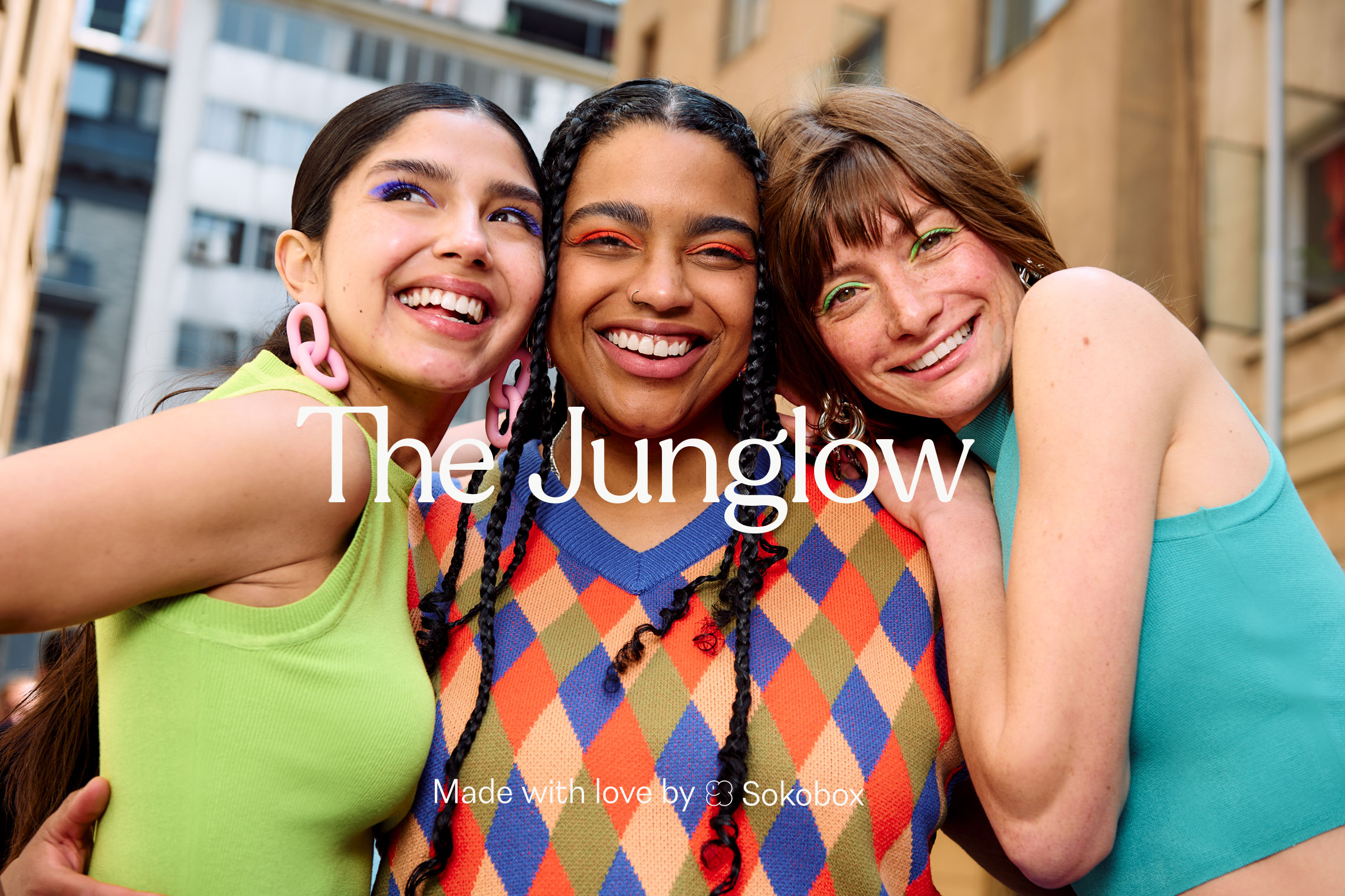 The Junglow wordmark placed over a colorful portrait of three smiling women.