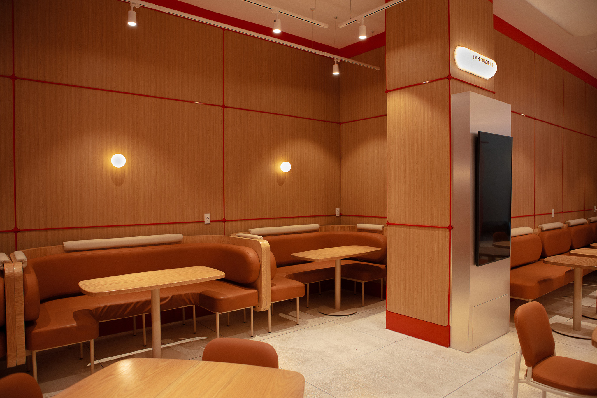 Interior design for Wings restaurant with warm-toned Mid-Century furniture.