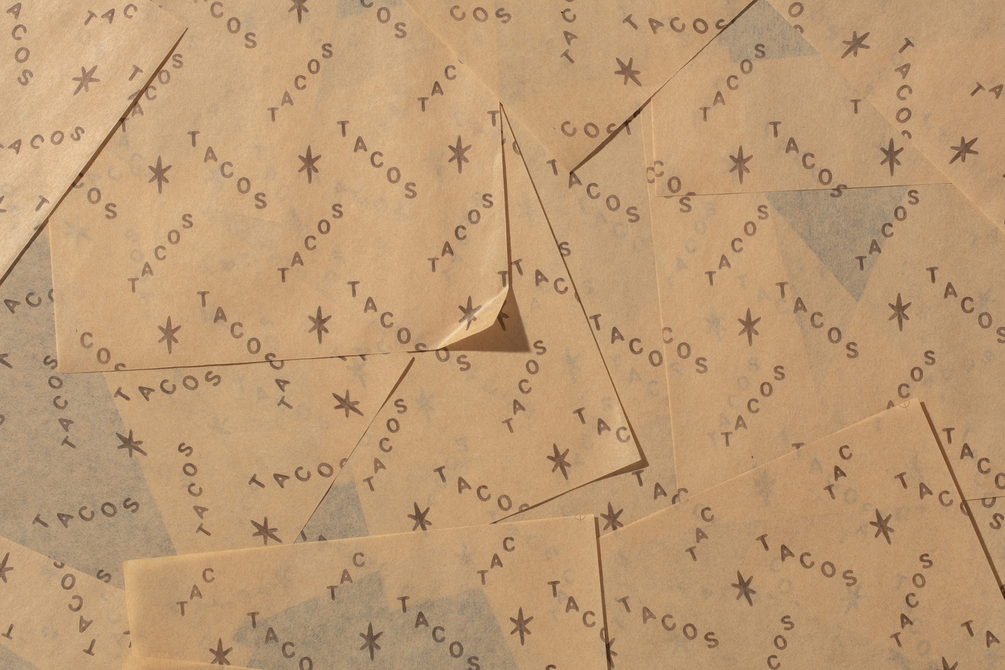 Wax paper with graphic pattern and custom typography for Taquería Desterrados.